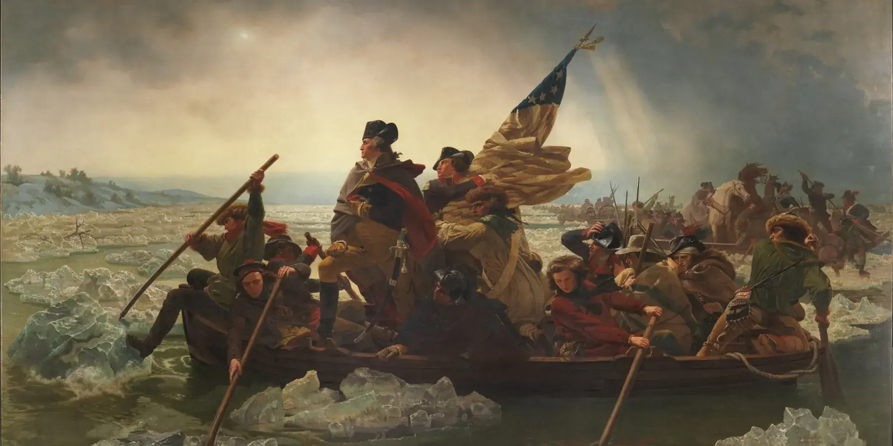 George Washington stands in a crowded boat as soldiers row through icy water, with an American flag behind him.