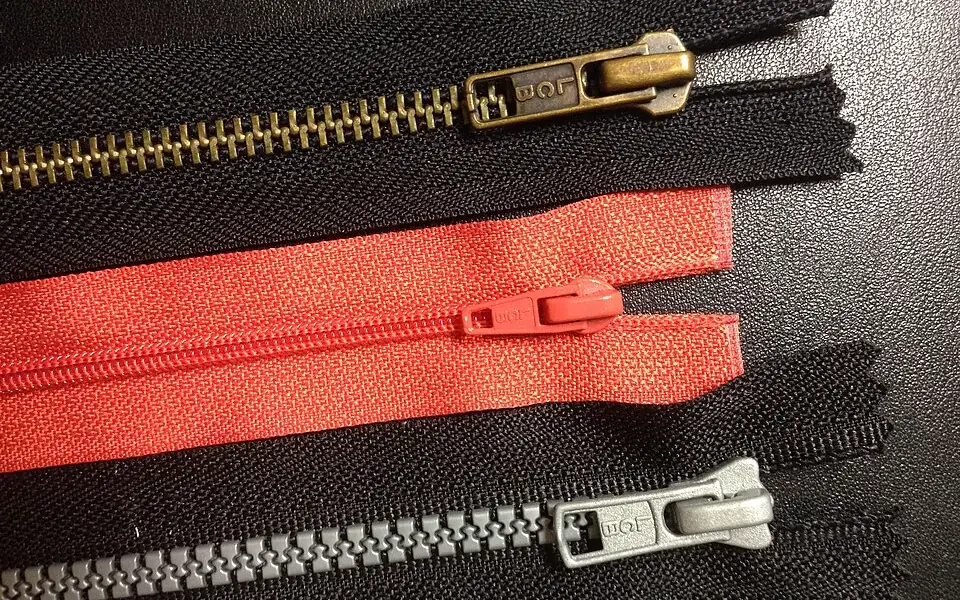 A zipper's slider joins two rows of teeth