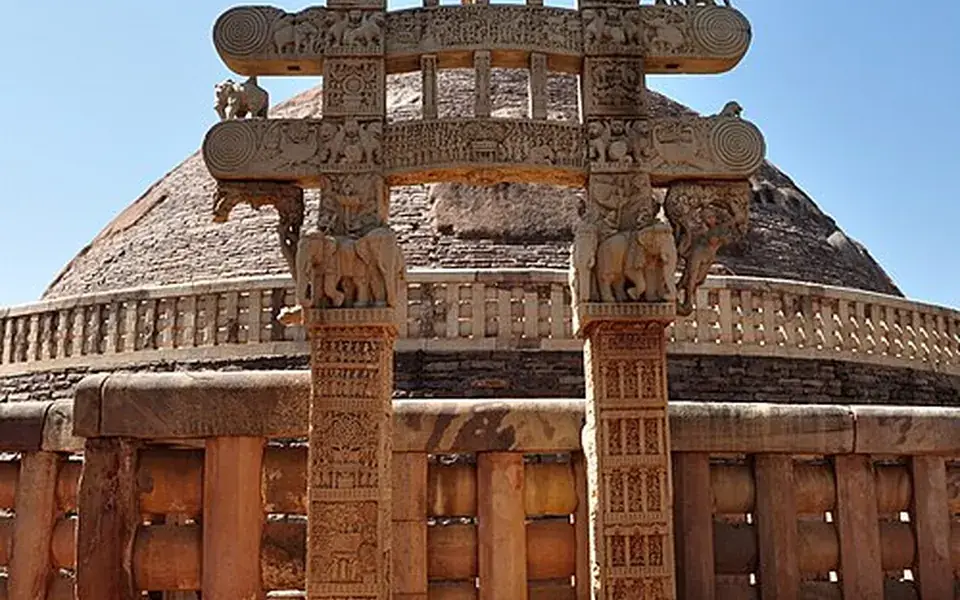 Carved gateways tell stories around a Buddhist stupa