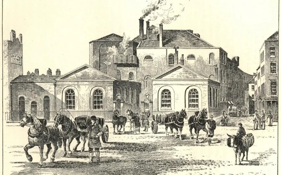 Historical view of Horse Shoe Brewery in London around 1800, with horse-drawn carts and people outside