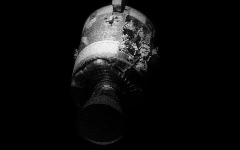The damaged Apollo 13 service module photographed after separation during the return to Earth